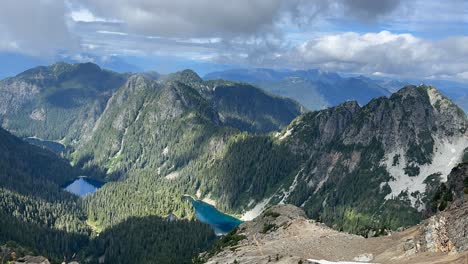 Timelapse-Hyperlapse-of-Mountain-Landscape-with-Bright-Blue-Lakes-and-Fast-Moving-Clouds-and-Blue-Sky-from-Incredible-View-Point-on-Mount-Brunswick-on-Howe-Sound-Crest-Trail-in-Canada-BC