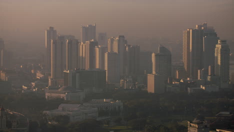 slow motion high altitude panning shot of manila bay towers at morning sunrise