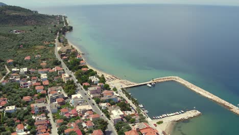 aerial pan up shot at skala sotiros resort on thassos island, greece to reveal the agean sea and mainland greece