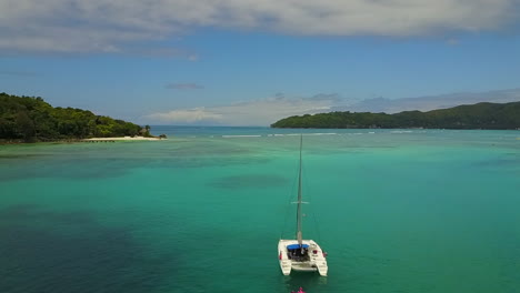 Sailingboat-anchors-in-beautiful-turquise-water,-Praslin,-Seychelles