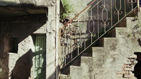 soldier climbs the stairs of an old house destroyed by bombs