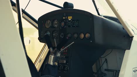 cockpit of a plane that is stationary in the airfield airport