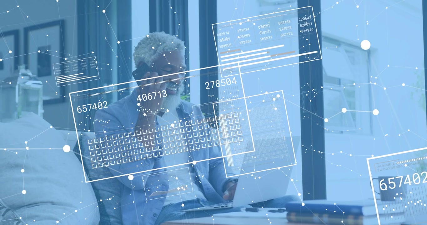 mature man speaking into smartphone and monitoring data panels updating over laptop digital grid