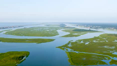 4k view of blue and green marsh near the ocean from above