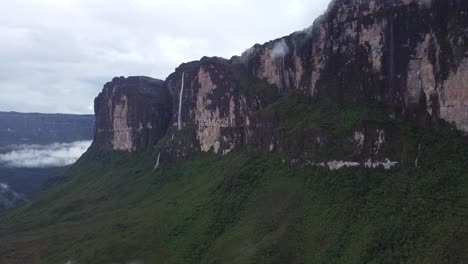 drone view of ancient tropical valley of tepuy roraima with huge waterfall