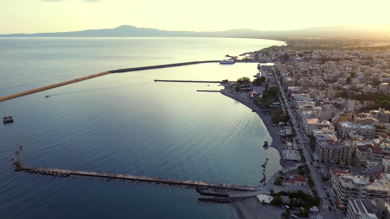 Aerial, bird's eye view, seaside of Kalamata , port visible on the background, bright sunset on a spring day 4K