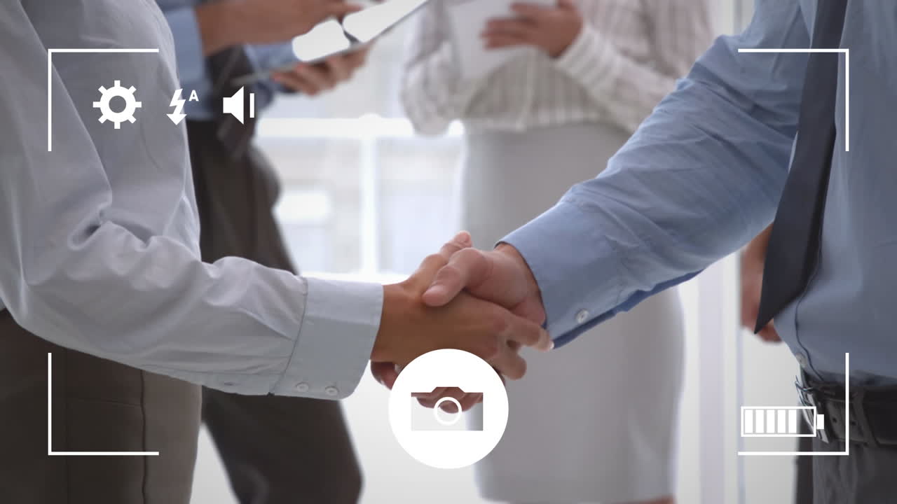 Taking photos of businessmen shaking hands on a digital camera