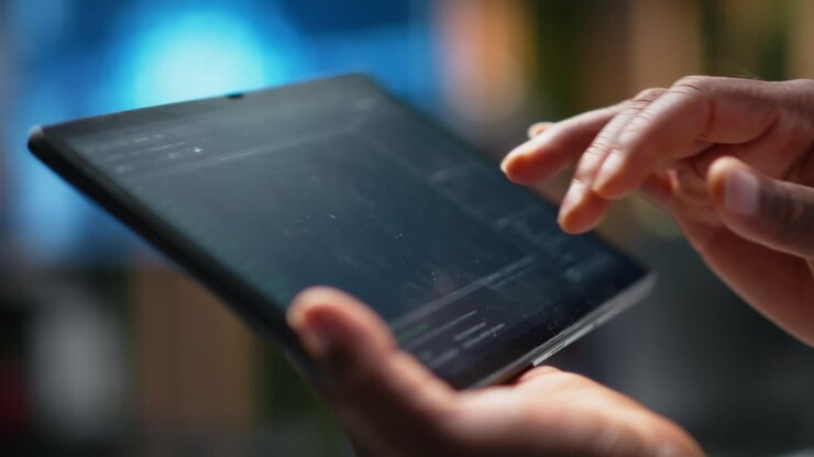 Close-up of Hands Using Digital Tablet for Coding and Development