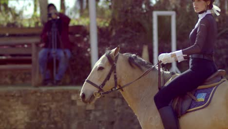 beautiful woman on light brown horse in slow motion