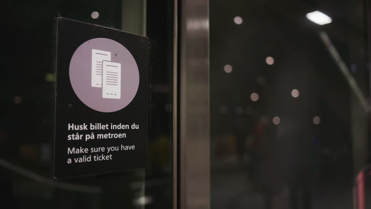Sign indicating to "Make sure you have a valid ticket" inside a metro in Copenhagen, Denmark