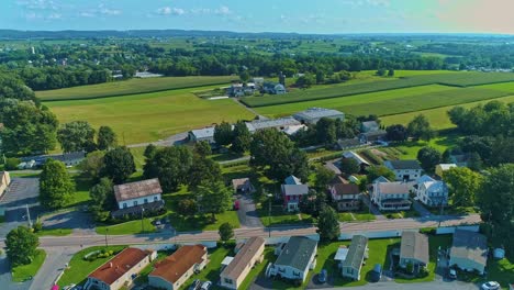 an aerial traveling view of corn fields and harvesting crops, with patches of color on a beautiful summer day