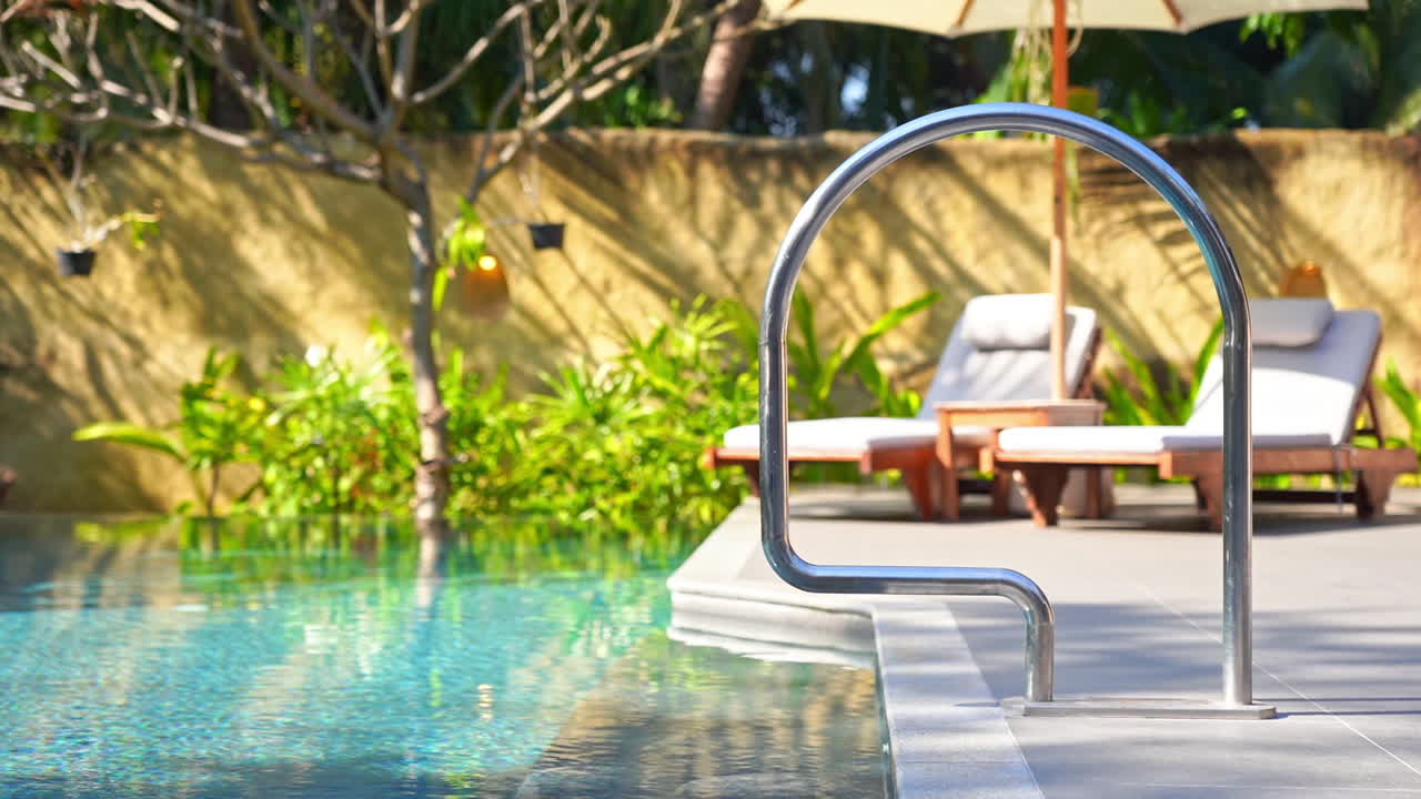 A posh swimming pool sits empty waiting for tourist