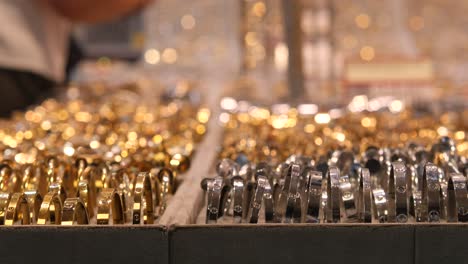 collection of gold and silver bracelets on display