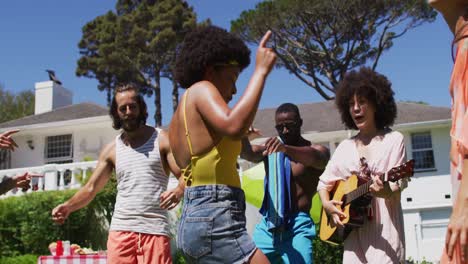 diverse group of friends having fun and dancing at a pool party