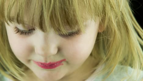 close-up of a child with red lipstick