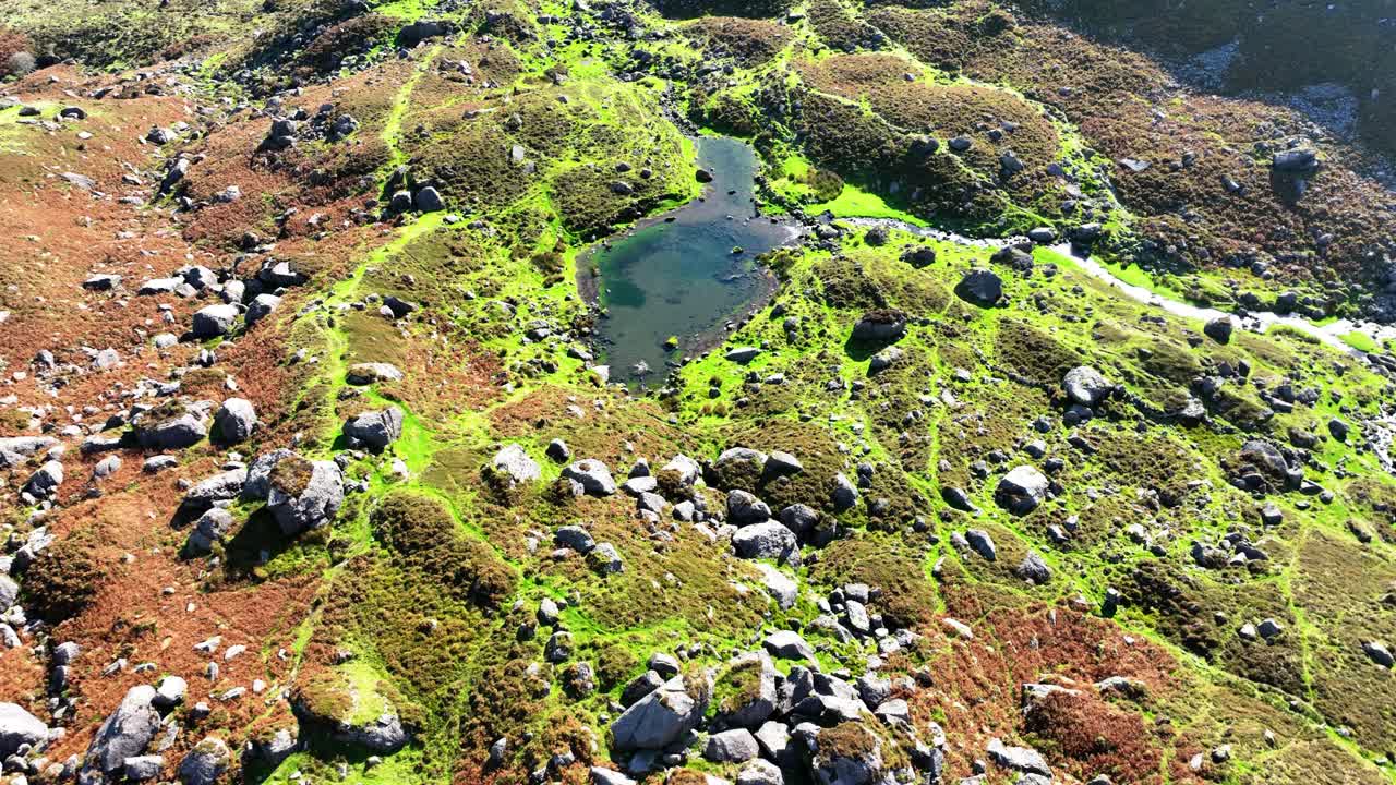 Irish Mountains drone flying slowly over rocks and small lake Coneragh Mountains Waterford epic locations