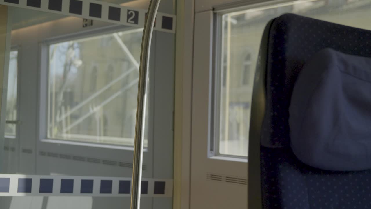 Inside view of a driving German ICE high-speed train with a seat and window visible