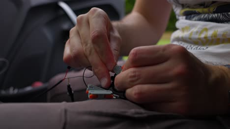 a person meticulously assembles small electronic components, capturing the detailed and intricate process of electronics work