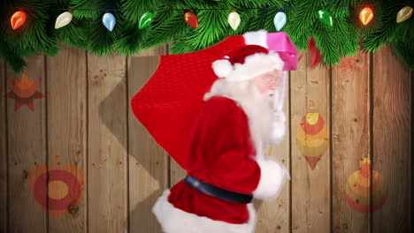 santa carrying sack of gifts against festive wooden background