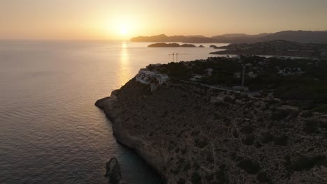 Birds-eye-view-over-coastal-limestone-cliff-during-golden-hour,-Mallorca