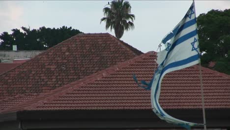 A-tattered-Israeli-flag-flies-during-the-war-with-Lebanon