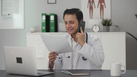 Happy-Indian-doctor-delivering-good-news-on-phone