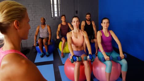 female trainer instructing people