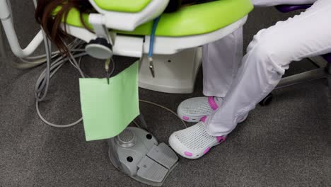 Closeup-view-od-the-dentist-leg-pushing-the-pedal-to-work-at-the-dentist-chair