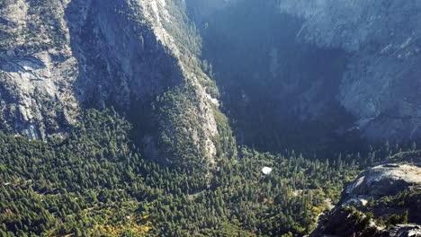 rising aerial shot of yosemite national park, popular tourist destination with waterfall