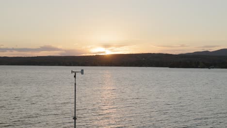 Weather-Vane-In-Lake-Magog,-Quebec,-Canada-At-Sunset
