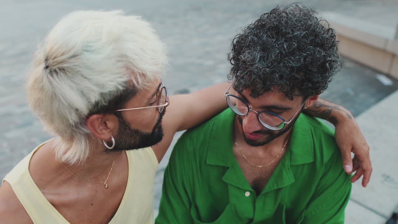 Happy Gay Couple Embracing and Talking Outdoors