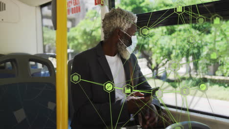 man wearing mask sitting on bus seat, holding smartphone and showing green finance network graphics