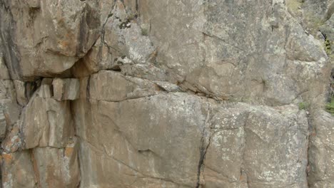 Aerial-pan-across-rock-cliff-in-Colorado