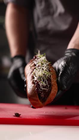 chef preparing gourmet hot dogs