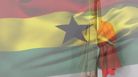 animation of flag of ghana waving over clothes on clothes valet against white wall