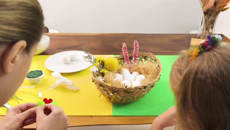 mom and daughter crafting easter decorations