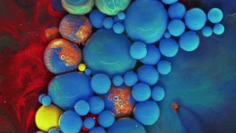 Colorful bubbles. Abstract blue, red, green mixture on a dark background. Artistic color paint background.