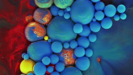 colorful bubbles. abstract blue, red, green mixture on a dark background. artistic color paint background.