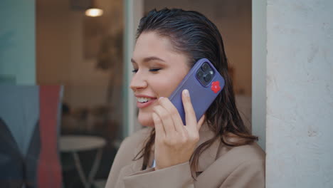 smiling girl gossiping cellphone call relaxing in cafeteria closeup. happy woman