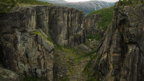 a gap on the rocky cliffs of hellmo canyon, tysfjord, northern norway