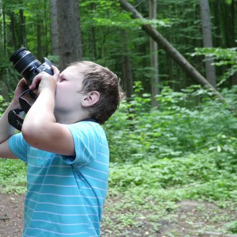 boy in wilderness area taking picture
