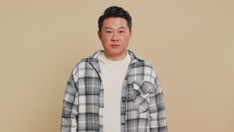 asian man raises thumbs up agrees give positive reply recommends advertisement likes good idea