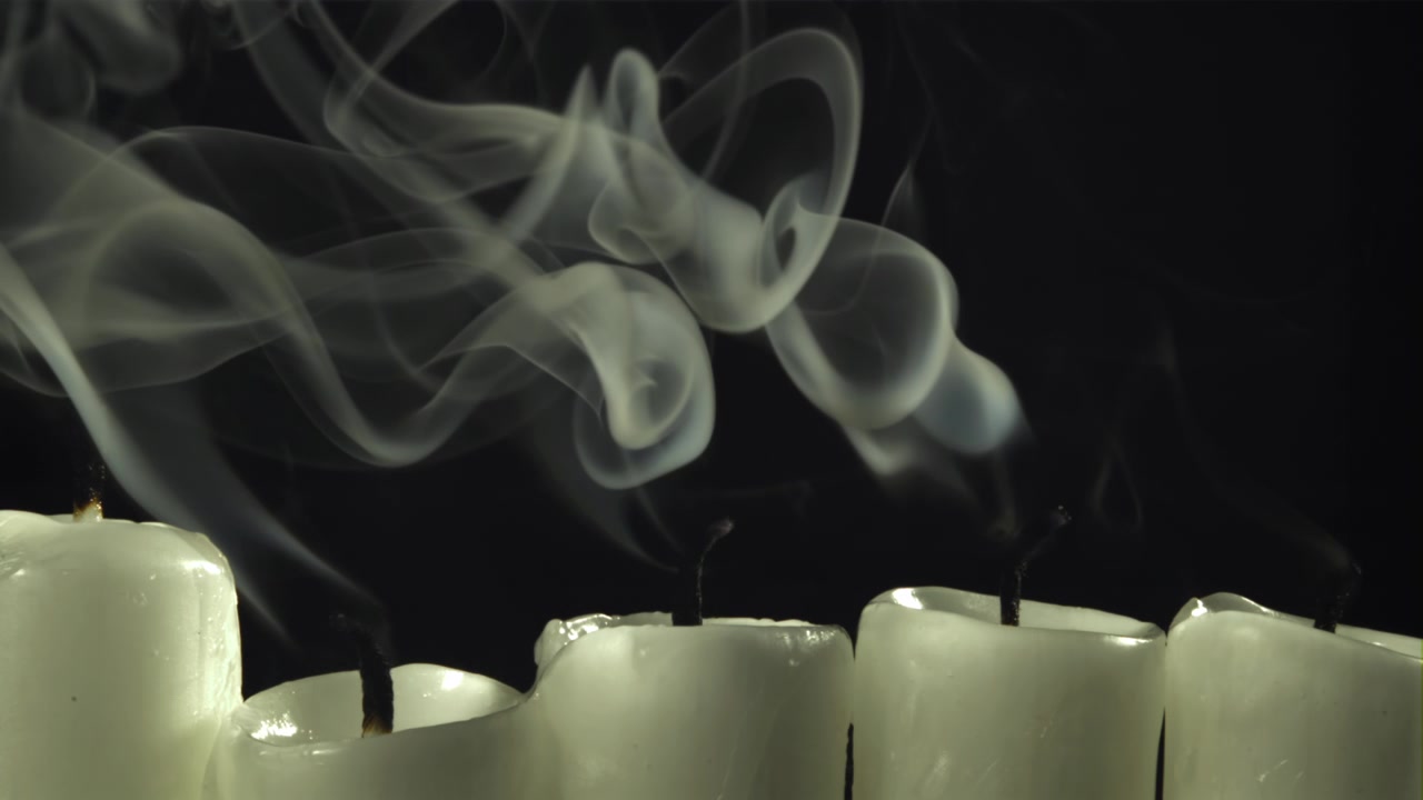 Ethereal White Smoke Rising from Extinguished Candles in Slow Motion