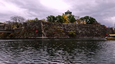 view from castle moat onto the famous osaka castle in japan