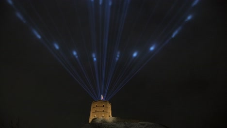 medieval castle with laser lights in the dark sky