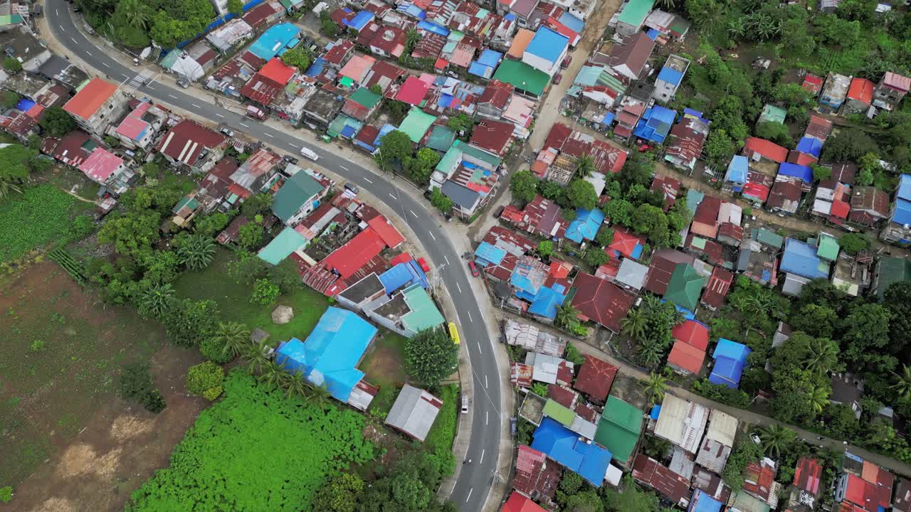 A road snakes through the landscape, connecting Mauban to the outside world, a vital artery for the community's economy and connectivity