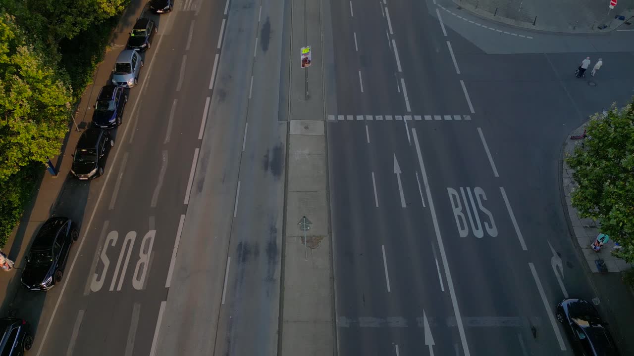 Berlin cityscape with residential buildings, a coca cola billboard, and cars moving along the streets. Magic aerial view flight tilt up drone