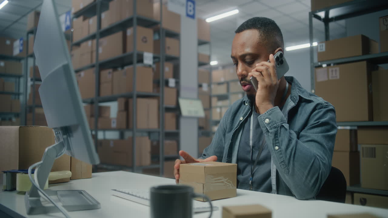 Warehouse Employee on Phone and Computer | Premium Stock Video Footage