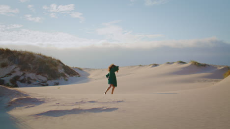 girl dancing sand dunes at summer evening. woman performing sensually movements.