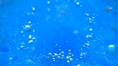 water abstract background. blue background. boiling liquid. chemical reaction in a liquid. close-up